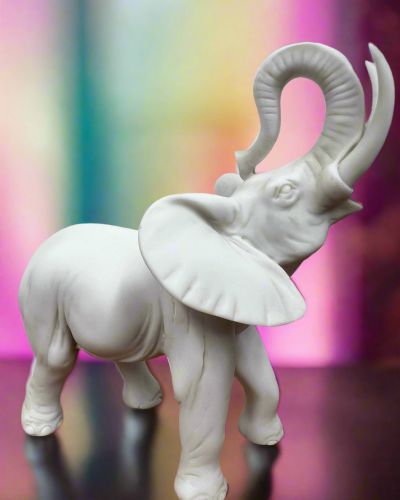 White Bonded Marble statue of elephant with trunk up in the air 