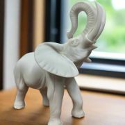 White Bonded Marble statue of elephant with trunk up in the air 